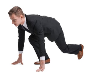 Photo of Businessman in starting position for run ready for competition on white background