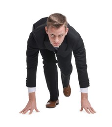 Photo of Businessman in starting position for run ready for competition on white background