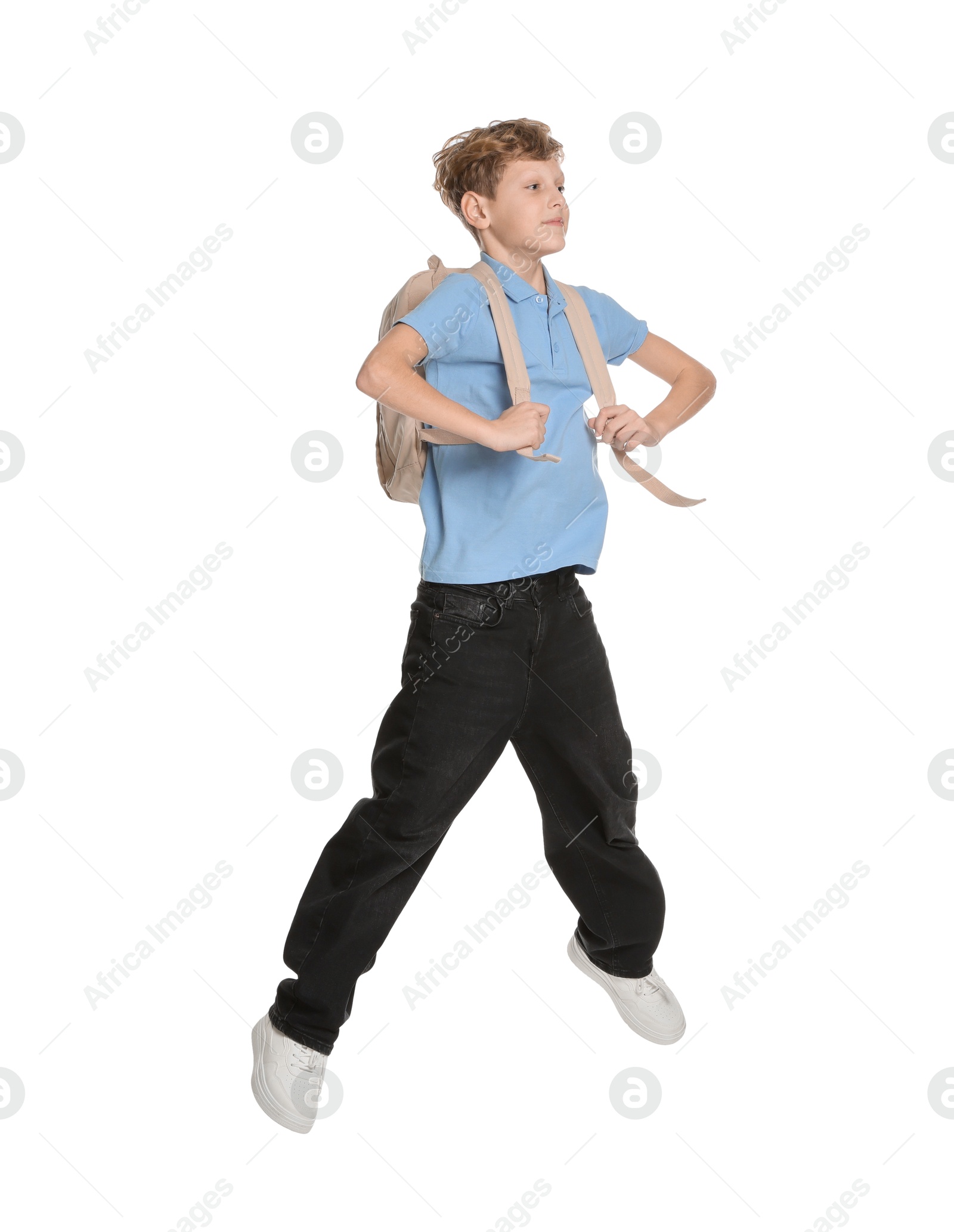 Photo of Teenage boy with backpack jumping on white background