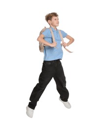 Photo of Teenage boy with backpack jumping on white background