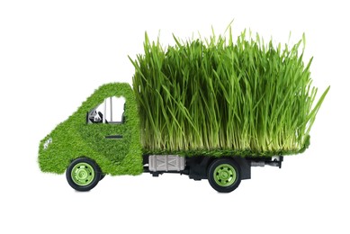 Image of Eco-friendly transportation. Truck covered with green lush grass on white background