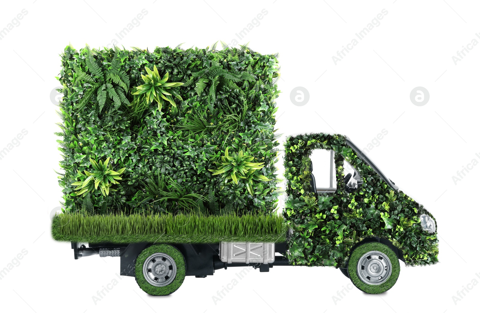 Image of Eco-friendly transportation. Truck covered with green lush grass on white background