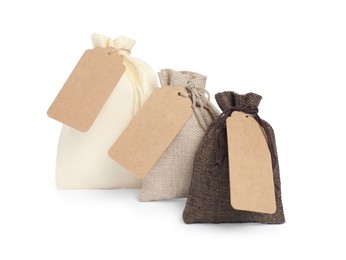 Photo of Burlap bags with tags isolated on white