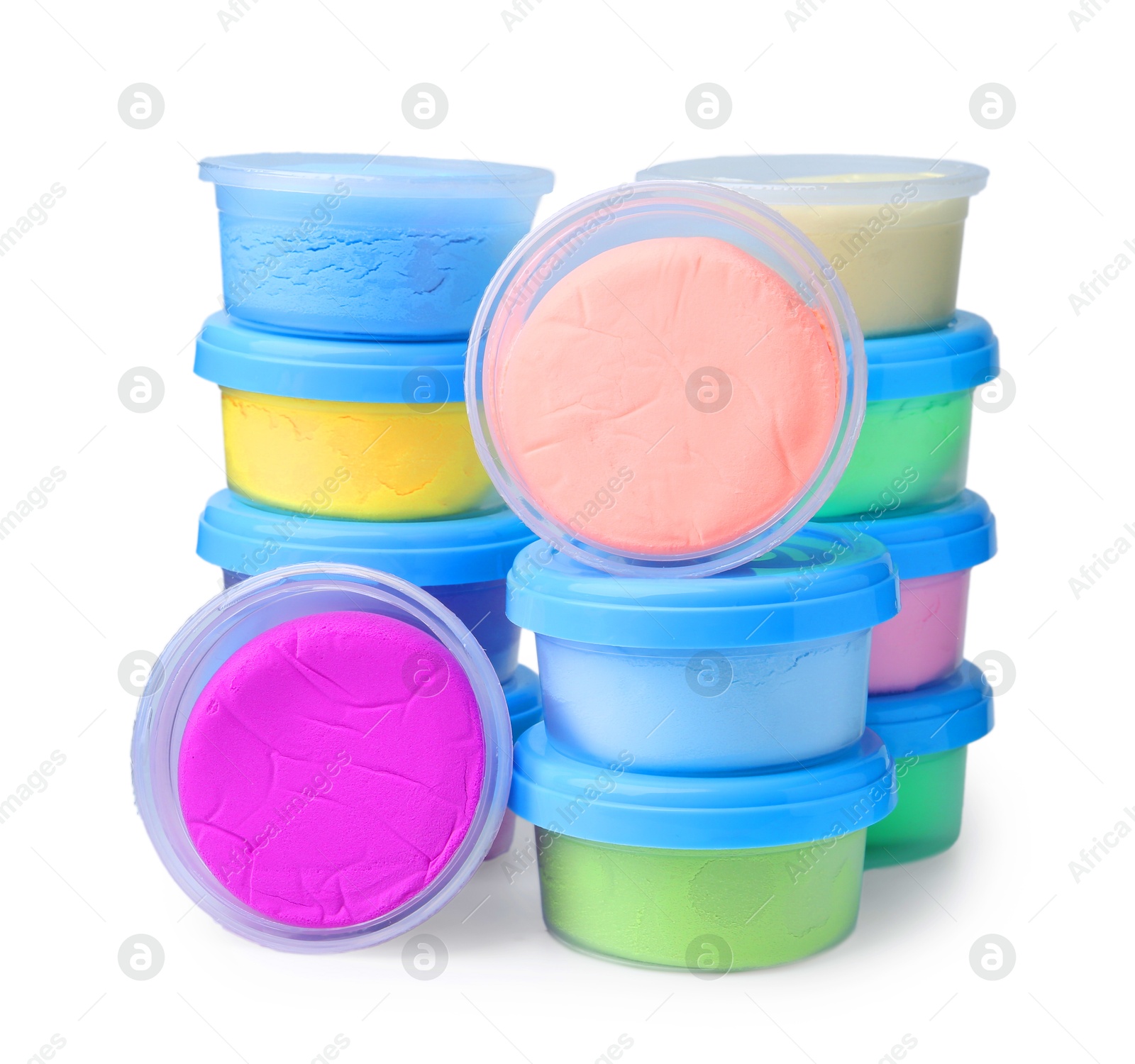 Photo of Different colorful modeling clay in plastic jars isolated on white