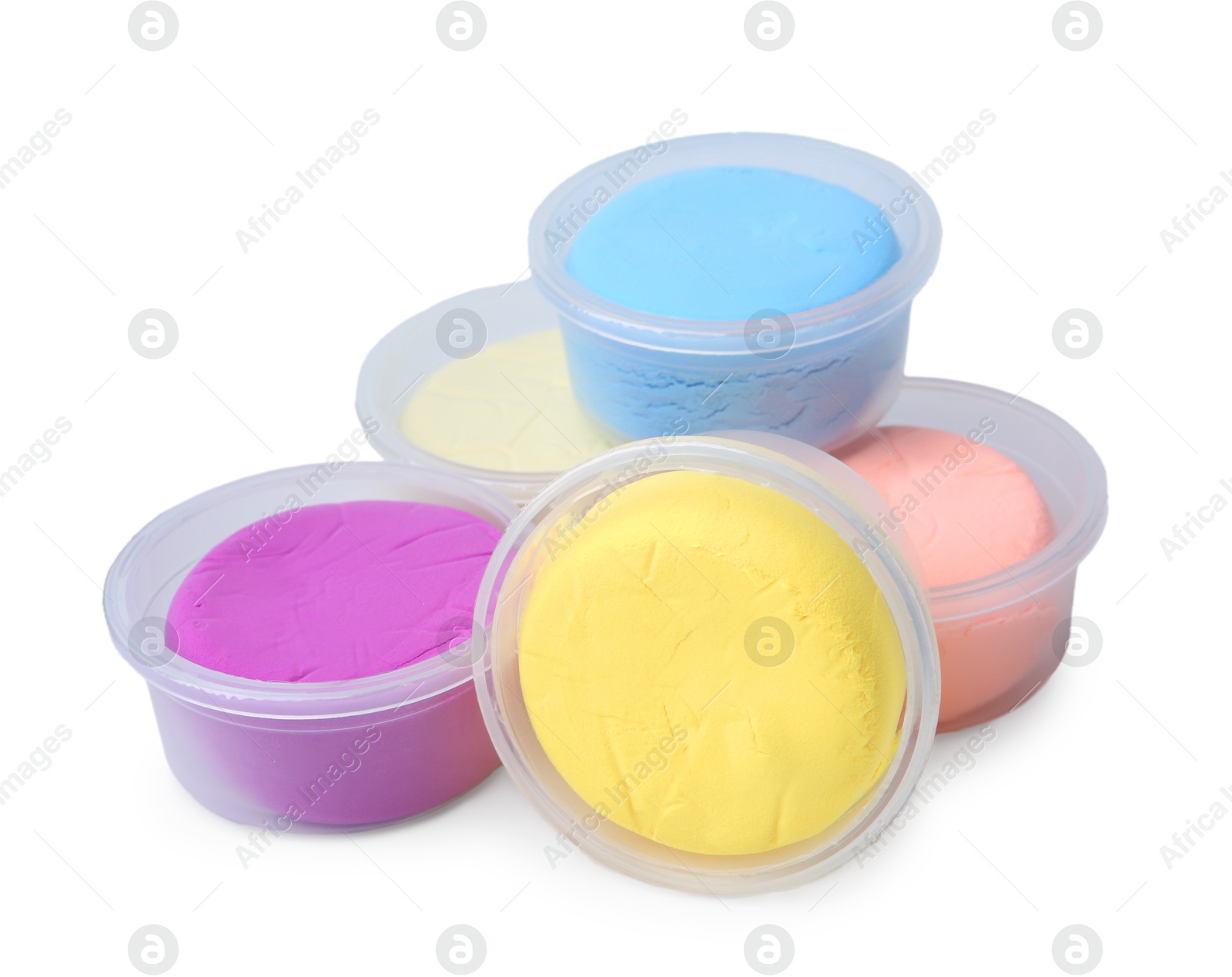 Photo of Different colorful modeling clay in plastic jars isolated on white