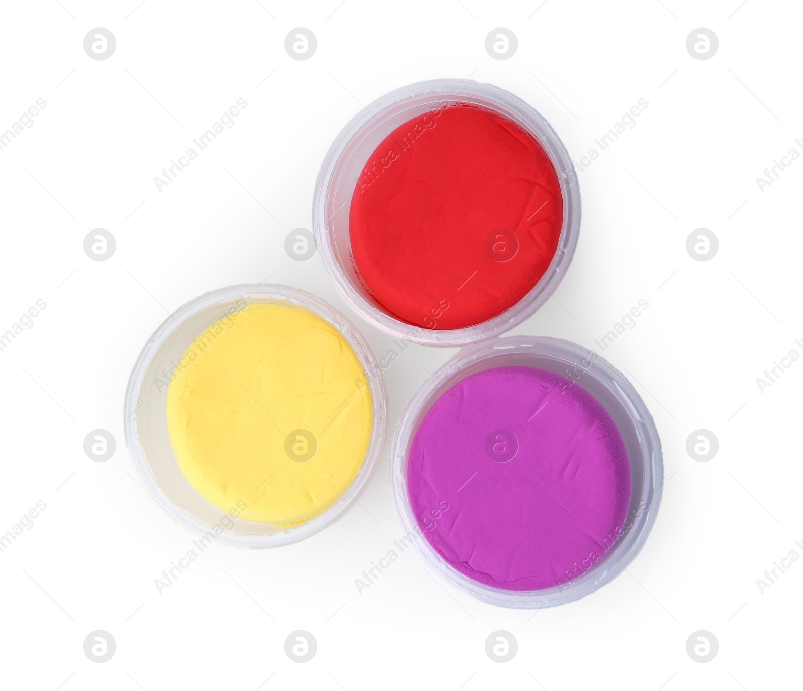 Photo of Different colorful modeling clay in plastic jars isolated on white, top view