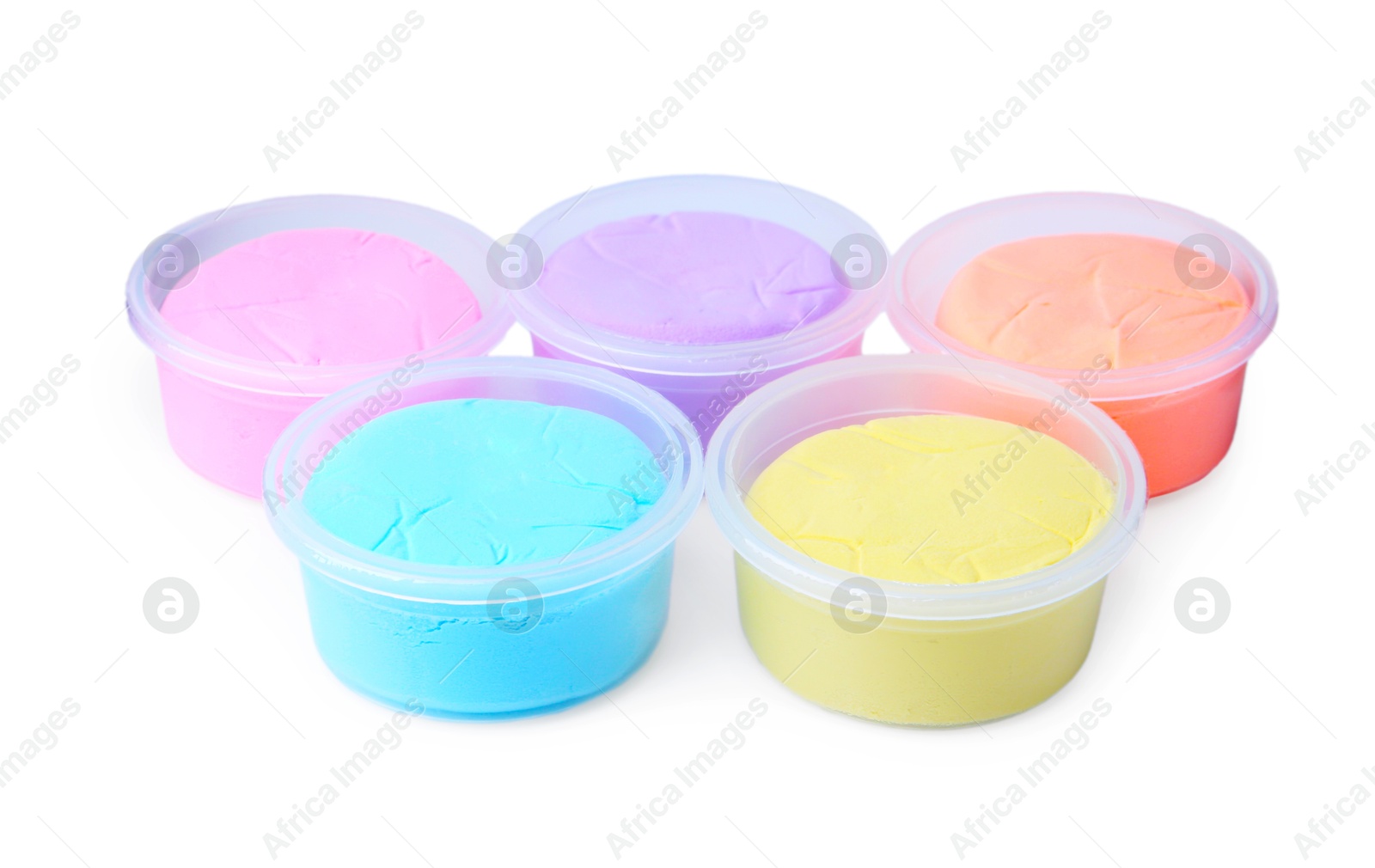 Photo of Different colorful modeling clay in plastic jars isolated on white