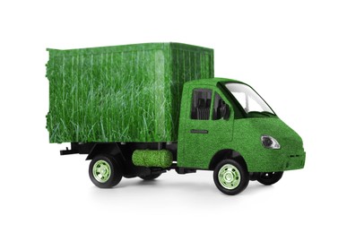 Image of Eco-friendly transportation. Truck covered with green lush grass on white background