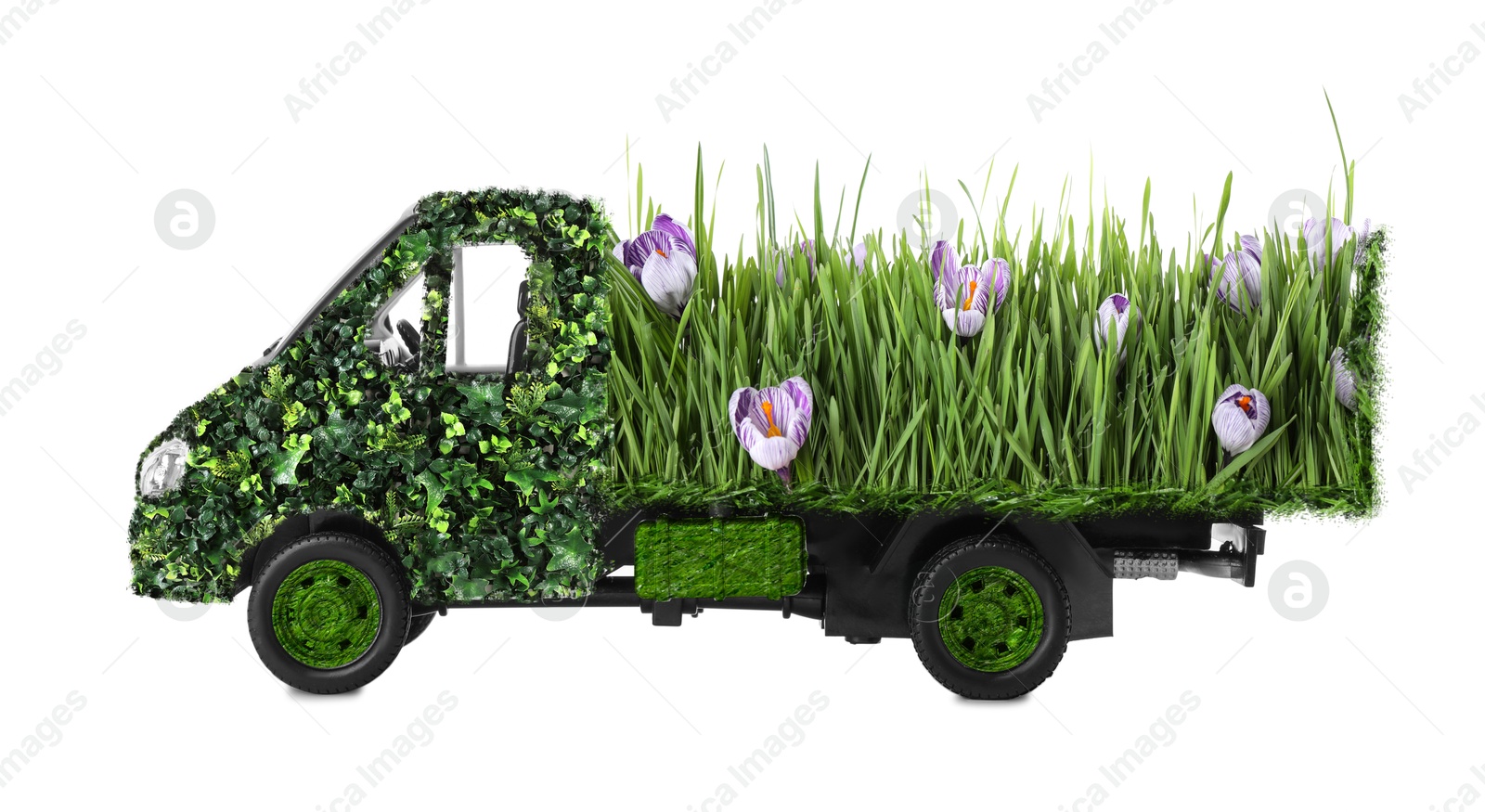 Image of Eco-friendly transportation. Truck covered with green lush grass and flowers on white background