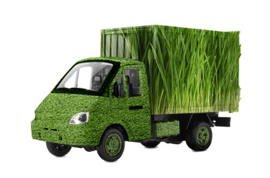 Eco-friendly transportation. Truck covered with green lush grass on white background