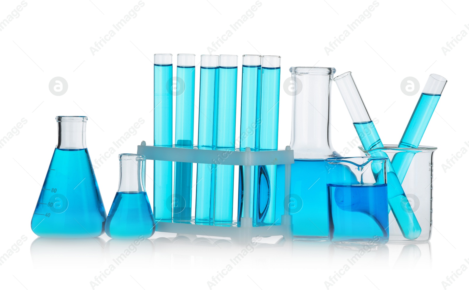 Photo of Laboratory glassware with blue liquid isolated on white