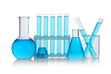 Photo of Laboratory glassware with blue liquid isolated on white