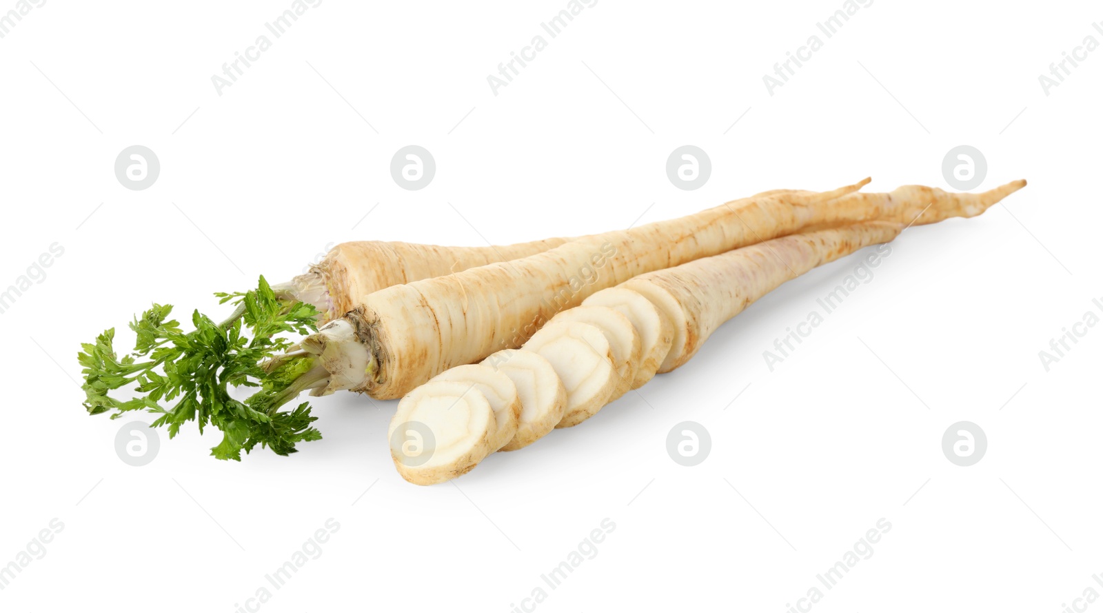 Photo of Whole and cut fresh parsley roots isolated on white