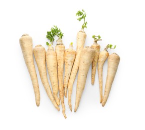 Photo of Many fresh parsley roots isolated on white, top view