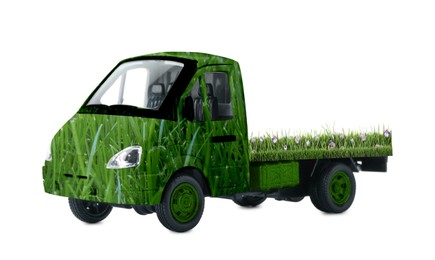 Image of Eco-friendly transportation. Truck covered with green lush grass on white background