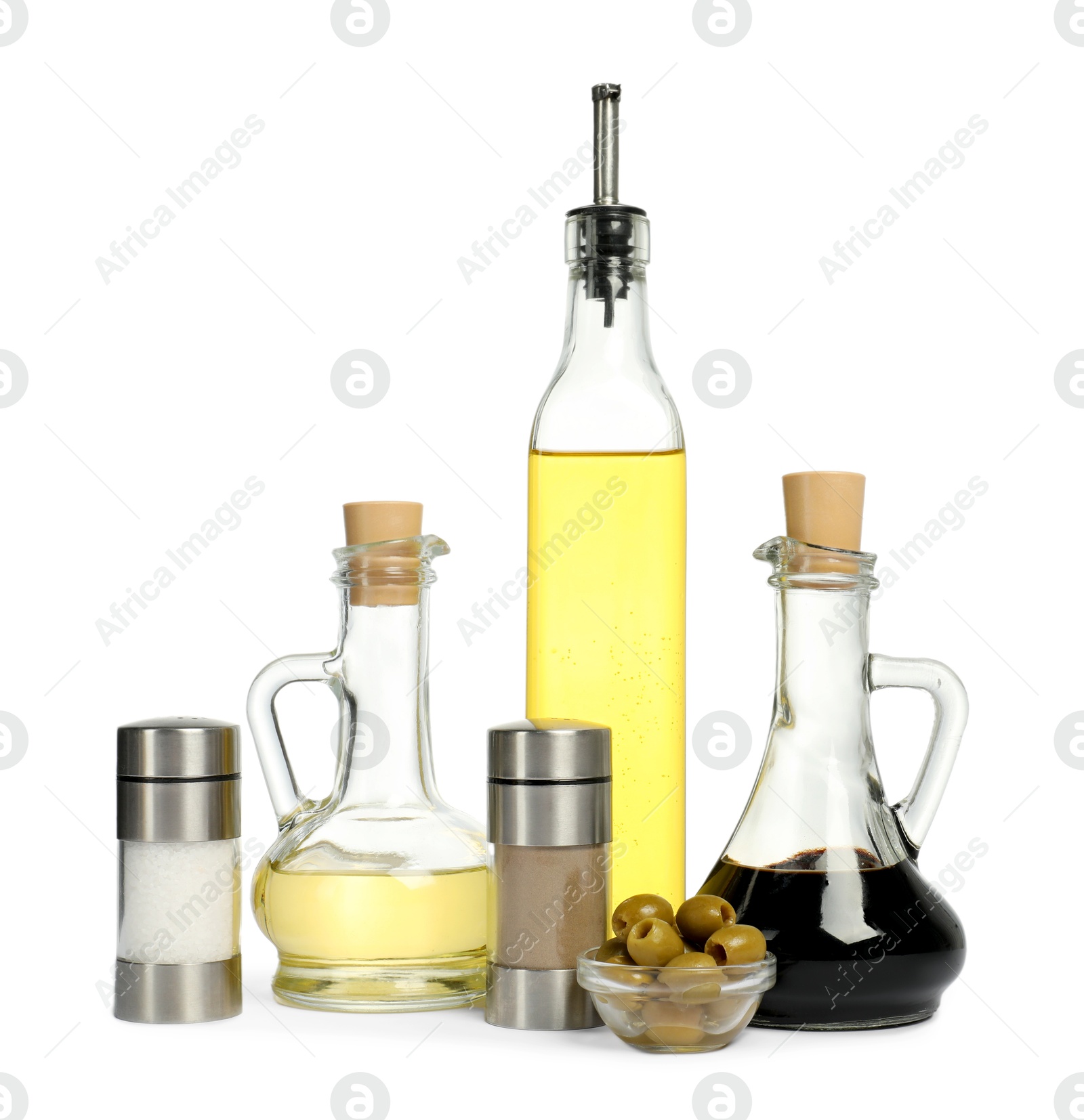 Photo of Salad dressings, olives and spices isolated on white