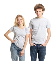 Photo of Young woman and man wearing blank t-shirts on white background. Mockup for design