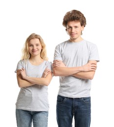 Photo of Young woman and man wearing blank t-shirts on white background. Mockup for design