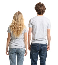 Photo of Young woman and man wearing blank t-shirts on white background, back view. Mockup for design