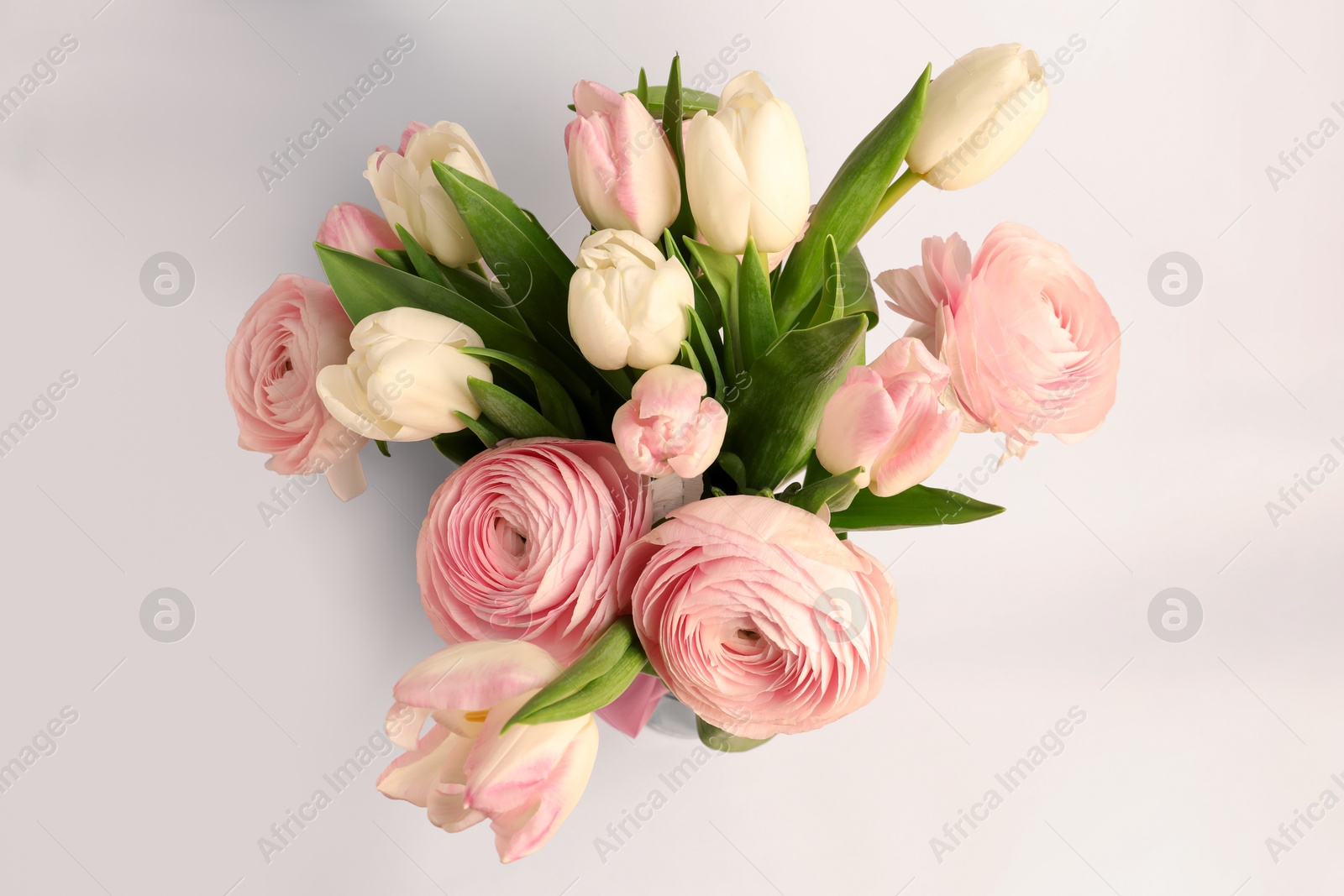 Photo of Bouquet of beautiful ranunculus and tulip flowers on white background, top view