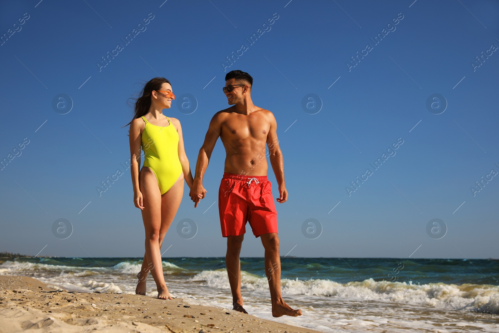 Photo of Lovely couple spending time together on beach