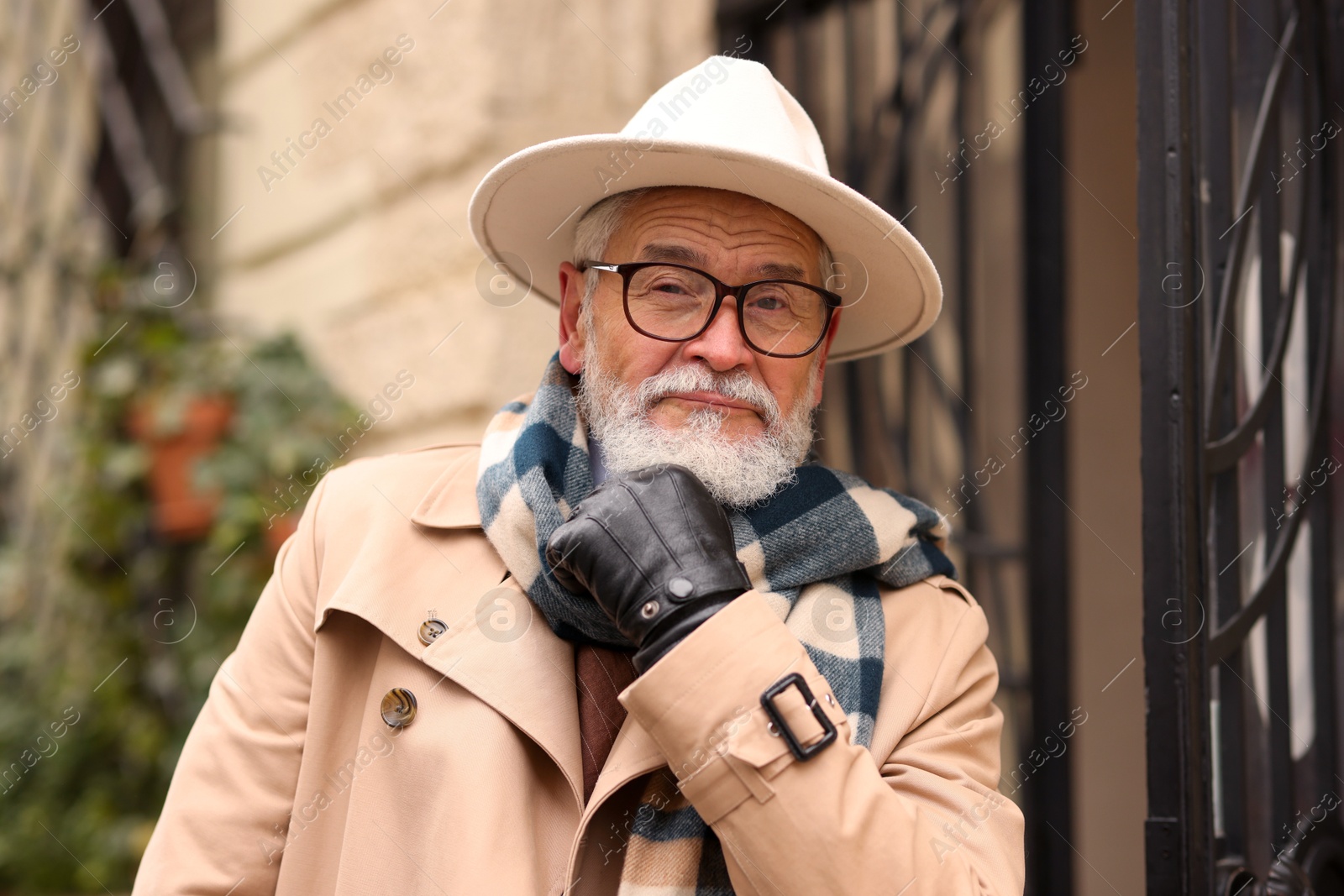 Photo of Stylish bearded senior man on city street