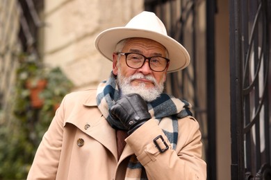 Photo of Stylish bearded senior man on city street