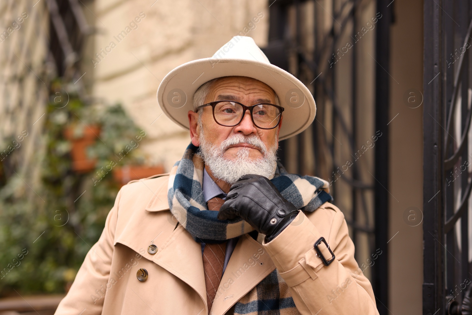 Photo of Stylish bearded senior man on city street