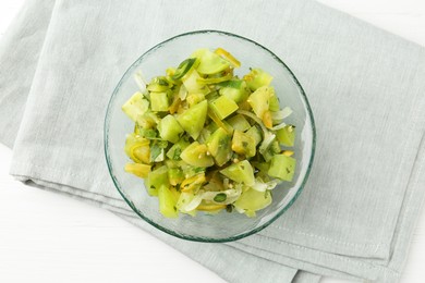 Photo of Delicious salsa (Pico de gallo) in bowl on white wooden table, top view