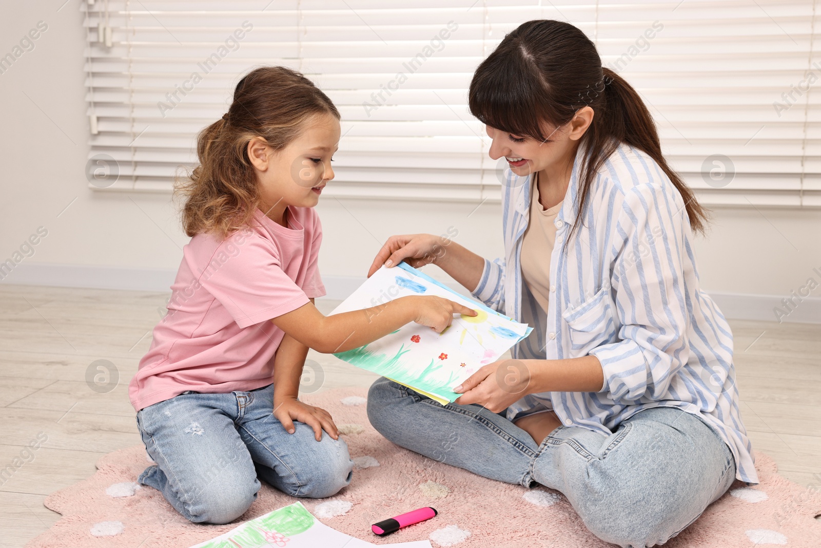 Photo of Smiling therapist working with little girl in autism treatment center