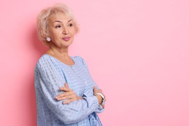 Photo of Portrait of elegant grandmother on pink background. Space for text