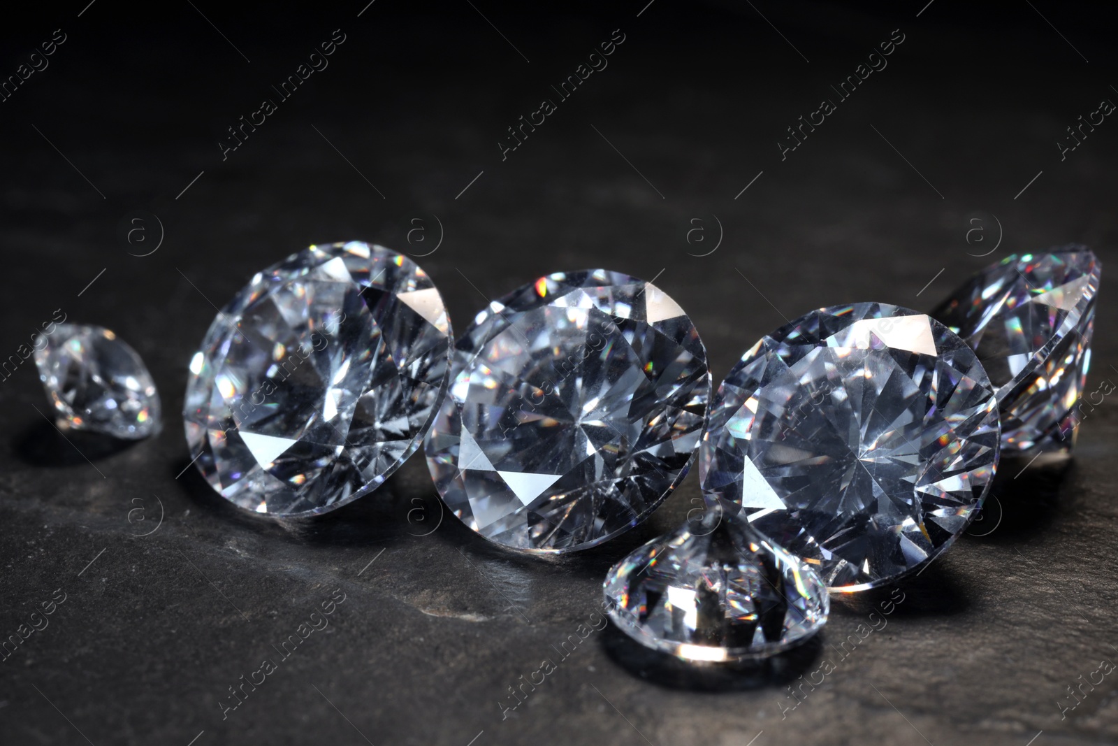 Photo of Beautiful shiny gemstones on black background, closeup