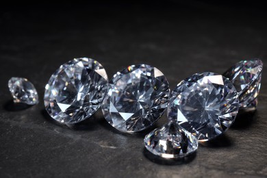 Photo of Beautiful shiny gemstones on black background, closeup