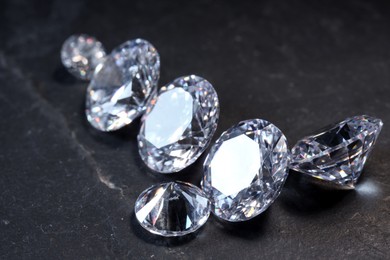 Photo of Beautiful shiny gemstones on black background, closeup