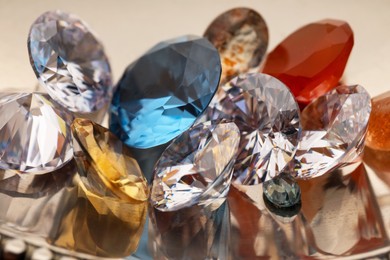 Photo of Beautiful shiny colorful gemstones on light background, closeup