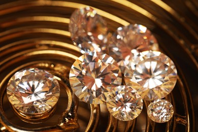 Photo of Beautiful shiny gemstones on golden tray, closeup