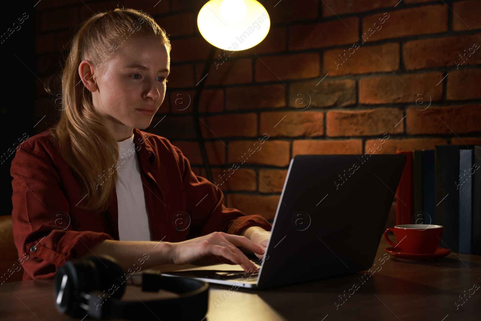 Photo of Woman working with laptop at table in office