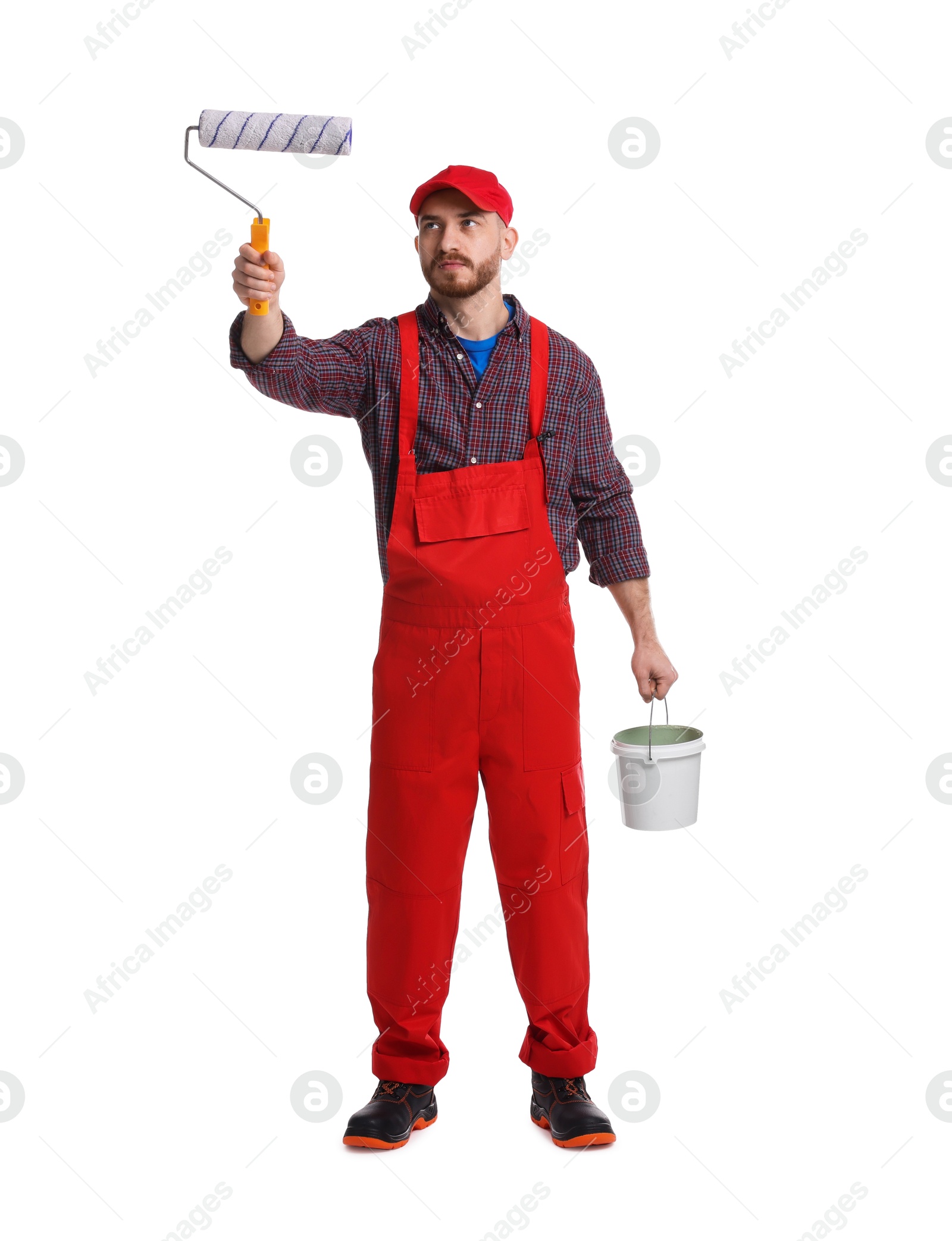 Photo of Professional painter with roller and bucket of paint working on white background