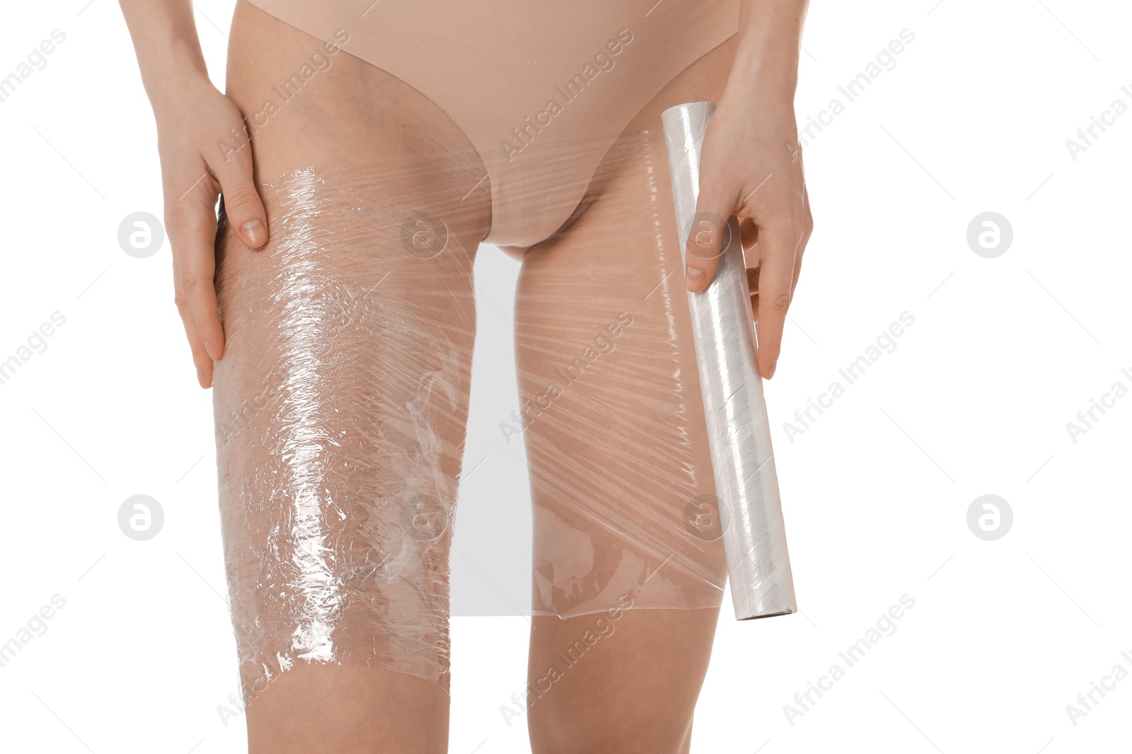 Photo of Woman doing spa body wraps on her leg against white background, closeup