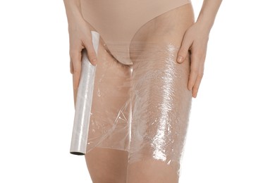 Photo of Woman doing spa body wraps on her leg against white background, closeup