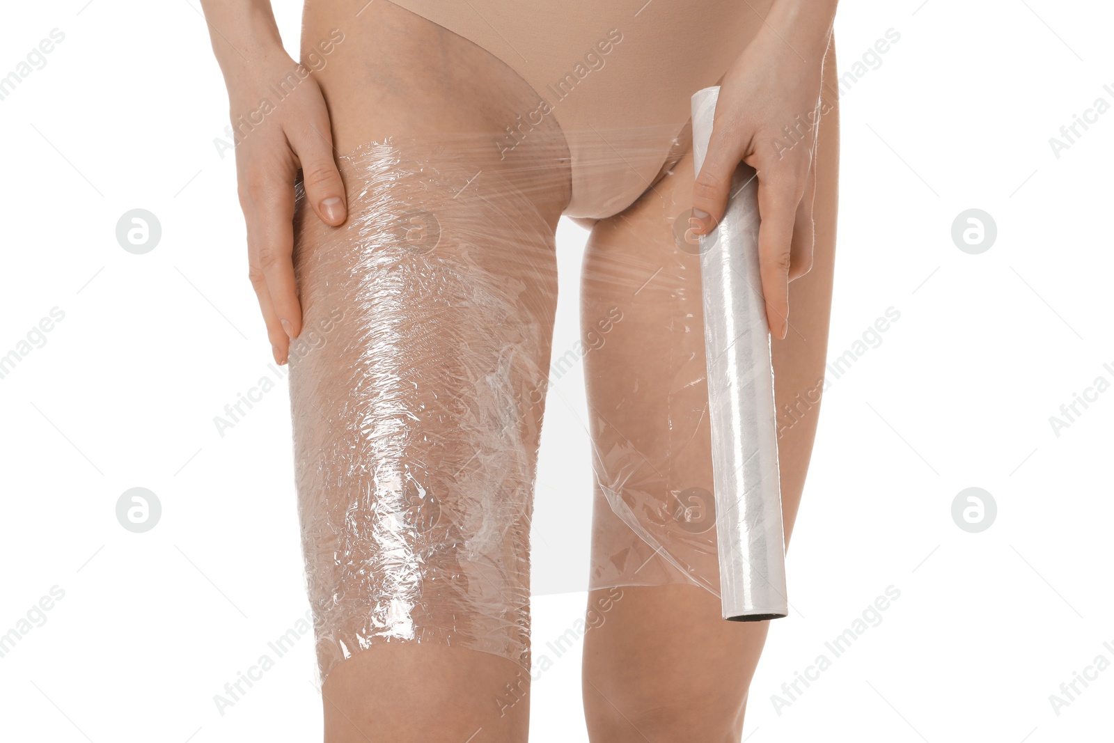 Photo of Woman doing spa body wraps on her leg against white background, closeup