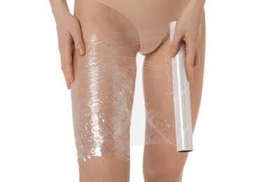 Photo of Woman doing spa body wraps on her leg against white background, closeup