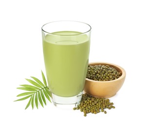Photo of Fresh mung bean juice in glass, seeds and green twig isolated on white