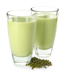 Photo of Fresh mung bean juice in glasses and seeds isolated on white
