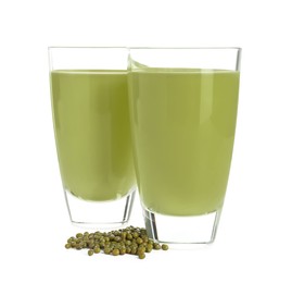 Photo of Fresh mung bean juice in glasses and seeds isolated on white