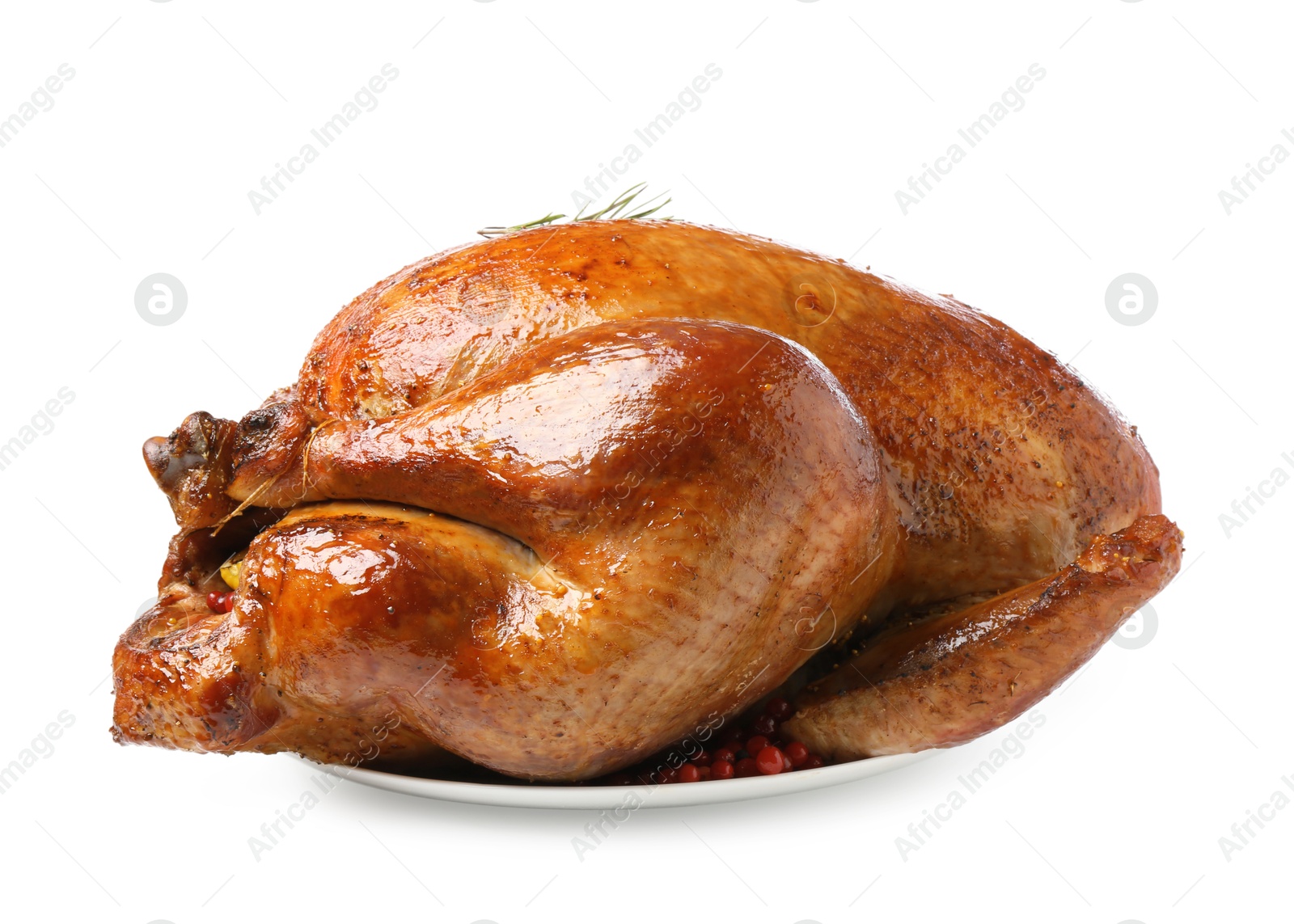 Photo of Whole baked turkey with cranberries and rosemary isolated on white