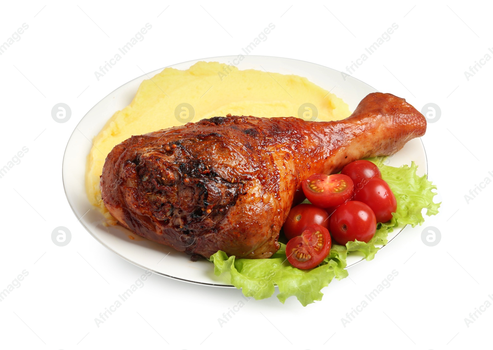 Photo of Baked turkey drumstick with mashed potato and tomatoes isolated on white