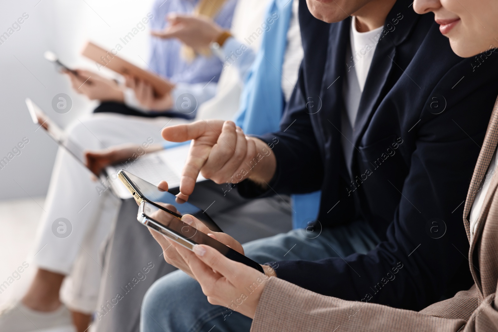 Photo of Group of people using different gadgets indoors, closeup. Modern technology