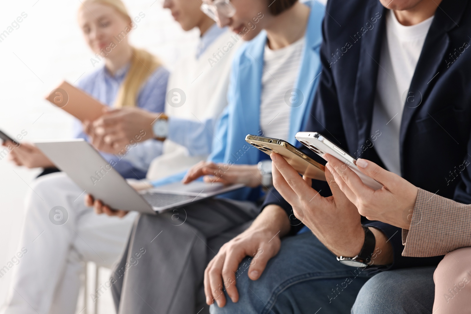 Photo of Group of people using different gadgets indoors, closeup. Modern technology