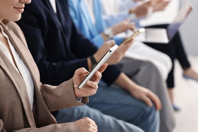 Photo of Group of people using different gadgets indoors, closeup. Modern technology